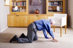 Person crawling toward chair after recovering from a fall